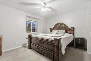 Bedroom featuring light carpet and ceiling fan