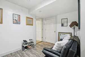 Sitting room featuring light wood-style floors and baseboards