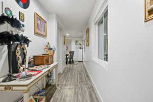 Hallway featuring wood finished floors and baseboards