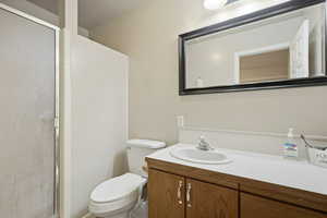 Bathroom featuring a shower stall and vanity