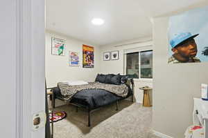 Carpeted bedroom with baseboards