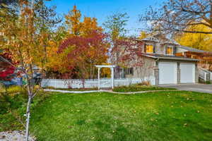 View of front of house with a fenced front yard and driveway