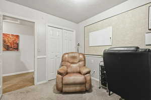 Office area featuring carpet and a textured ceiling