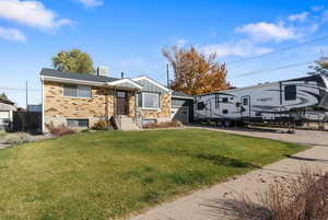 View of front of home featuring brick siding, driveway, board and batten siding, and an attached garage