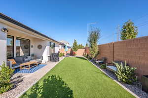 Fenced backyard featuring an outdoor living space and a patio