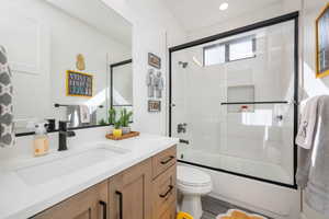 Full bathroom featuring vanity and combined bath / shower with glass door