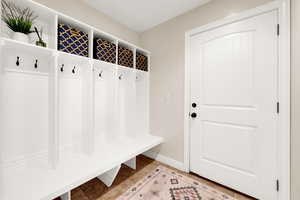 Mudroom featuring light tile patterned flooring and baseboards