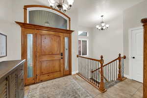 Entryway featuring a chandelier and light tile patterned floors