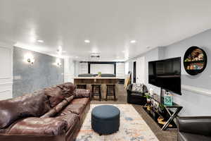 Living area featuring light colored carpet, recessed lighting, and crown molding