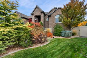 French country style house with brick siding and a gate