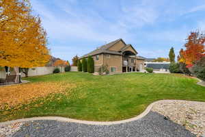 View of side of property with a fenced backyard, stucco siding, stairs, and a balcony