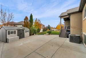 View of patio / terrace featuring stairway and a storage unit