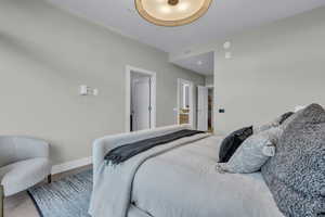 Bedroom with baseboards and ensuite bath