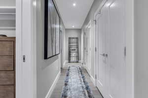 Corridor featuring light wood-style floors and recessed lighting