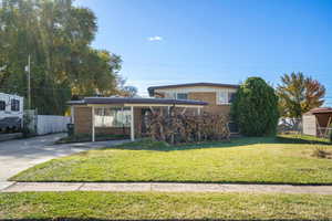 Traditional-style home featuring brick siding and driveway