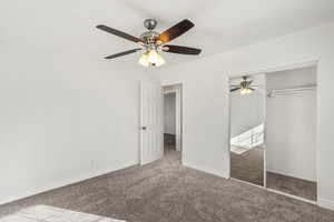 Unfurnished bedroom with carpet flooring, ceiling fan, and a closet