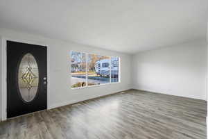 Foyer featuring wood finished floors and baseboards
