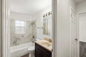 Full bathroom featuring vanity and a combined bath / shower with marble appearance