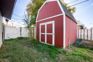 View of shed featuring a fenced backyard