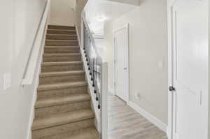 Stairs featuring baseboards and wood finished floors