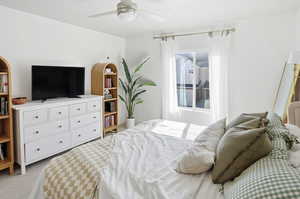 Bedroom with light carpet and ceiling fan
