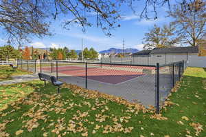 View of tennis court with a mountain view