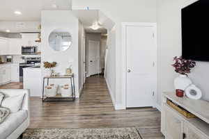 Kitchen with backsplash, stainless steel appliances, light countertops, light wood-type flooring, and recessed lighting