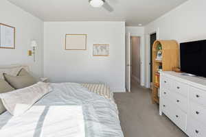 Bedroom with light carpet and ceiling fan