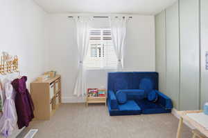 Playroom with carpet flooring and baseboards