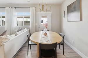Dining area featuring wood finished floors and a chandelier