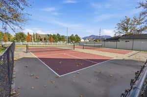 View of tennis court featuring a mountain view