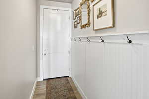 Doorway to outside with wood finished floors and baseboards