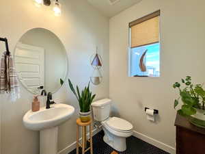 Bathroom featuring toilet and tile patterned flooring