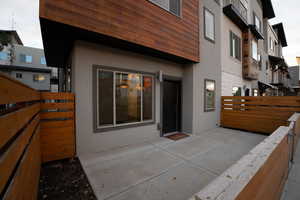 Rear view of house with stucco siding and stone siding