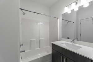 Bathroom featuring vanity and  shower combination
