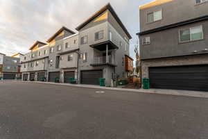 View of building exterior with an attached garage and a residential view
