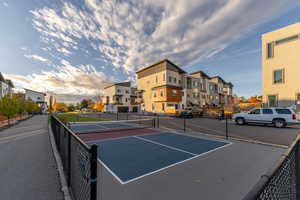 View of tennis court featuring a residential view