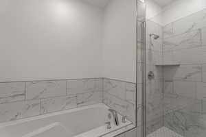 Bathroom with a bath and a shower stall