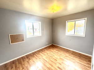 Spare room with baseboards and light wood finished floors