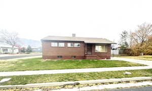 View of front of home featuring brick siding and a mountain view