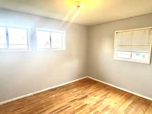 Empty room featuring baseboards and light wood-style floors