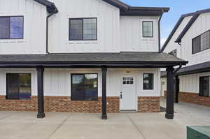 View of front facade featuring board and batten siding, a porch, and a shingled roof