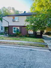 View of front of home with brick siding and a front lawn