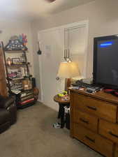 Sitting room with carpet flooring and baseboards. APT 2