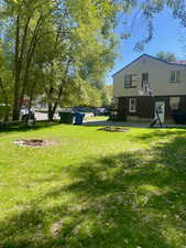 View of green lawn featuring a deck