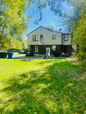Rear view of property with a deck, a lawn, and a chimney. North looking South