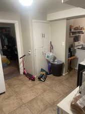 Laundry room featuring light tile patterned floors. APT 2