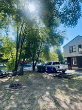 View of yard featuring an outdoor fire pit. North side looking South