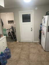 Laundry area with light tile patterned floors and baseboards. APT 2