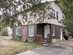View of front of home featuring brick siding. NE corner, APT 1 entrance.